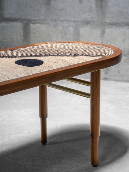 Further details of the Ela Accent Table, showing the texture of the banana fiber top and the sleek combination of wood and brass. This piece is designed as art furniture, a unique statement for any space.