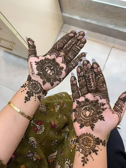I love adding personal touches to my mehendi designs. In this photo, you can see the name 'Ishant' subtly incorporated into the intricate pattern, making the design unique and special for the client.