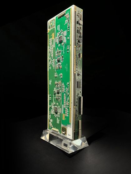 A sleek, modern award made from a vertically mounted circuit board on a clear acrylic base. These designs are perfect for companies looking to feature remarkable, eco-conscious awards at their events.