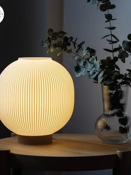 This spherical, ribbed table lamp provides a gentle, diffused glow. It's an excellent choice for creating a cozy and inviting atmosphere on tables in a cafe or as accent lighting in a salon's reception.