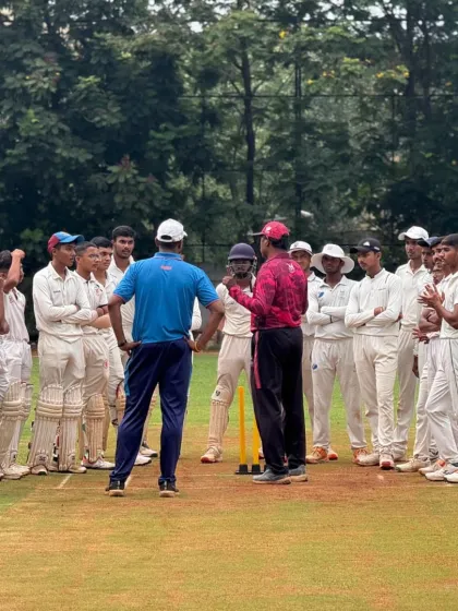 Coaches discussing the day's play with the U-16 team after their match.