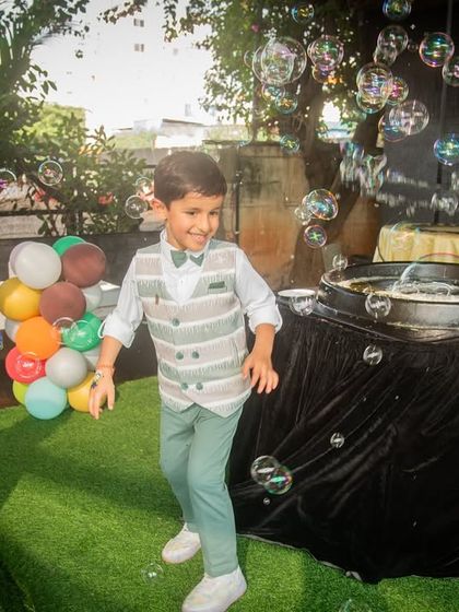 The birthday boy dances with joy amidst a flurry of bubbles. These action shots are full of energy and perfectly capture the spirit of a celebration.
