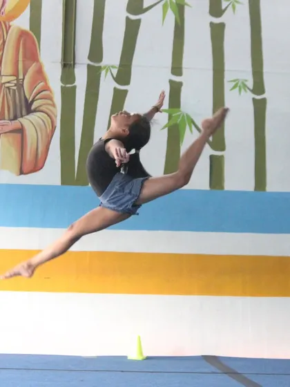 Another powerful split leap, demonstrating the height and extension our gymnasts work towards in their floor and beam routines.