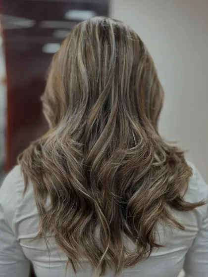 The back view of this ash blonde balayage showcases the beautiful, cool tones and the healthy shine of the hair.