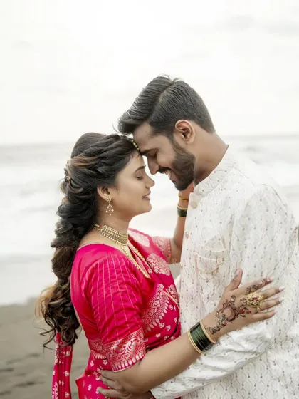 An intimate pre-wedding portrait on the beach, capturing the quiet connection between the couple.