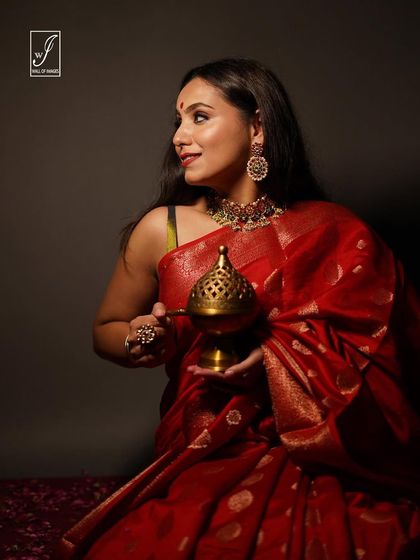 A profile view from the festive saree shoot, highlighting the model's traditional jewelry and the rich color of the fabric.