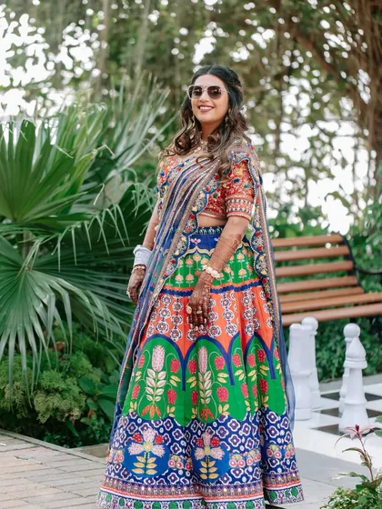 The bride looking cool and chic in sunglasses at her mehendi carnival. The makeup is fun and durable, perfect for an outdoor event.