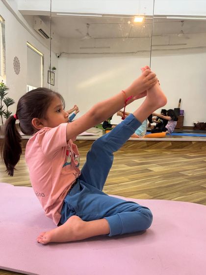 This young yogini is working on her Krounchasana, or heron pose, showing great flexibility and control. I am always so proud of their progress.
