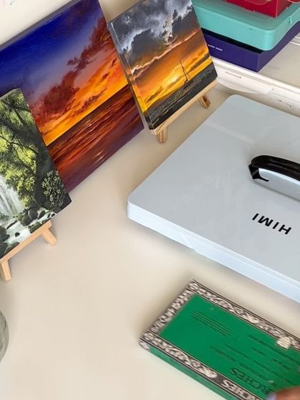 A shot of my desk showing some of my finished paintings, including the koi pond piece, ready to be packed.