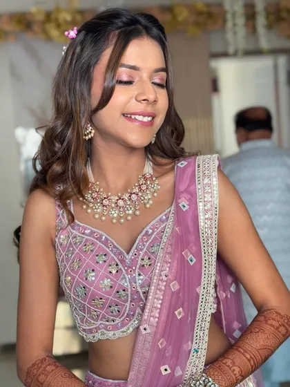 A candid, happy moment. The hairstyle is designed to be light and comfortable, perfect for enjoying a long day of wedding festivities.