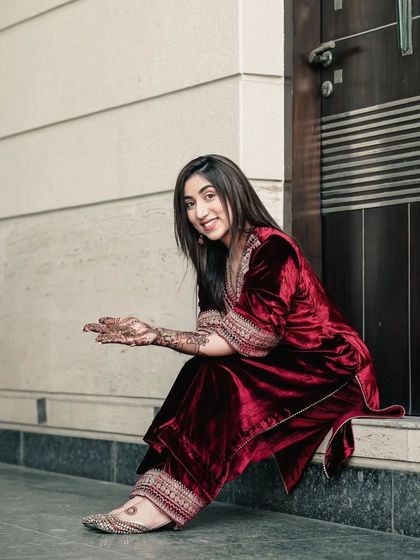 A happy client showing her mehandi-adorned hands. We cater to guests as well as brides, providing designs for everyone at the event.