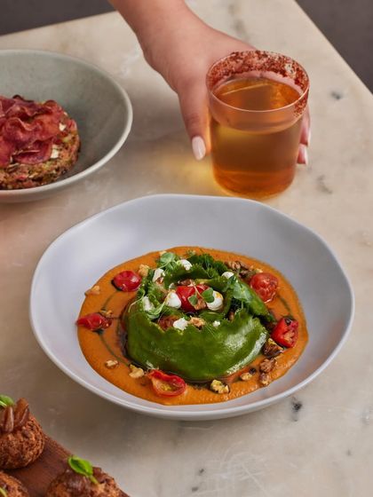 One of our most popular brunch bowls, the spinach and ricotta crown ravioli. The dish combines a charred tomato and miso sauce with toasted walnuts and goat cheese for a true texture bomb.
