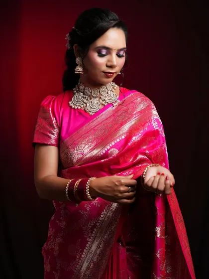 An elegant look in a traditional pink silk saree, with makeup that is both classic and modern.