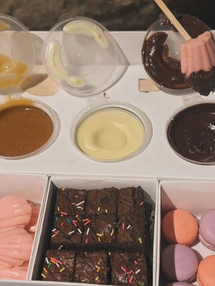 My Exotic Dessert Box is pure indulgence. It's filled with mini macarons, strawberry madeleines, double chocolate brownie bites, and three dipping sauces: chocolate, salted caramel, and white chocolate.