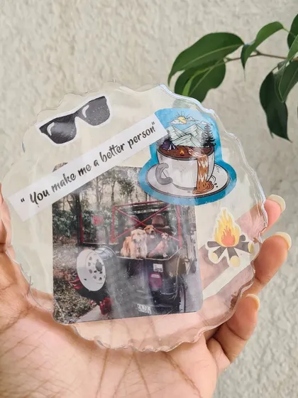 This personalized resin coaster captures a perfect memory. It includes a photo of beloved pets, a meaningful quote, and stickers that represent a love for the outdoors.