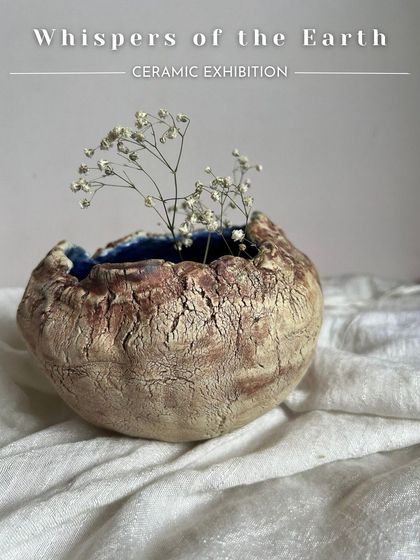 This beautiful, rustic vase with a cracked texture and a deep blue interior was made by the artist Mukta. It perfectly captures the raw beauty of the earth.