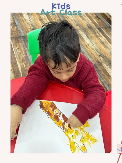 A toddler creating a giraffe using a handprint. This is a classic, fun activity that turns a simple handprint into a piece of art.
