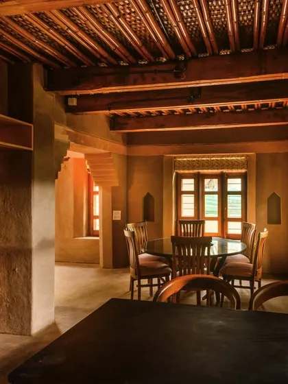 This image shows the view from the kitchen into the dining area, a space designed for connection. I used the existing light to create a warm, intimate atmosphere, highlighting the intricate wooden ceiling and the way the different areas of the home flow into one another.