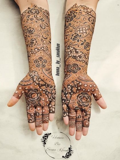 A beautiful example of a full-coverage bridal design, featuring a mix of bold roses and delicate, fine-line patterns for a balanced look.