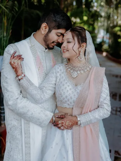 Creating beautiful memories together. I help couples coordinate their looks for their special day, ensuring both bride and groom look picture-perfect. This image captures the elegance of a coordinated couple in our rental ethnic wear.
