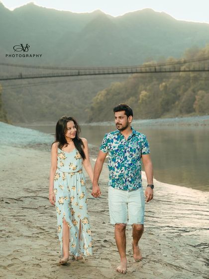 A romantic walk along the riverbank during a pre-wedding shoot in Rishikesh, with the mountains providing a stunning backdrop.