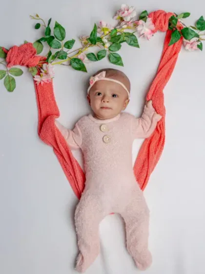 Hanging out in the garden. This creative shot of a baby on a floral swing is a fun and unique way to incorporate natural elements.