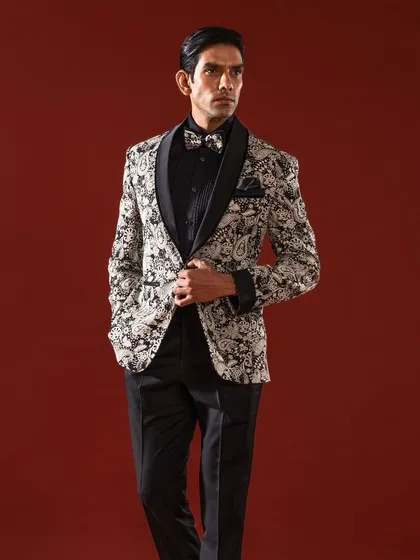 For the man who appreciates bold elegance, this tuxedo jacket features a striking black and white paisley print. Paired with a black formal shirt and trousers, it creates a confident and stylish look for any celebratory event.