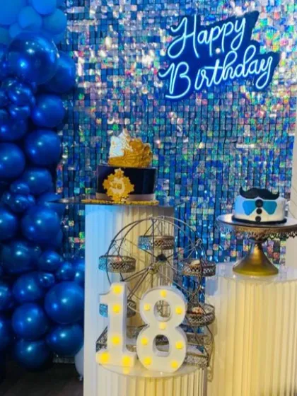 This shot showcases the two custom cakes for the 18th birthday party, one with a crown and one with a mustache theme.