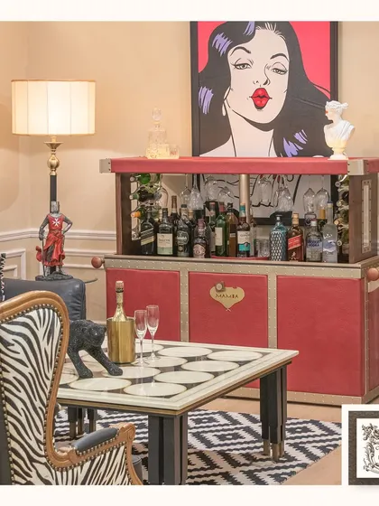 Make a bold statement with the Mamba automated bar. Its vibrant red leather finish and sleek design conceal a complete bar setup, perfect for modern and eclectic interiors.
