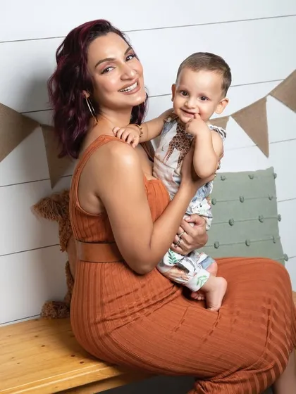 A tender moment between a mother and her son. Her smile and his curious expression perfectly capture the beautiful bond they share.