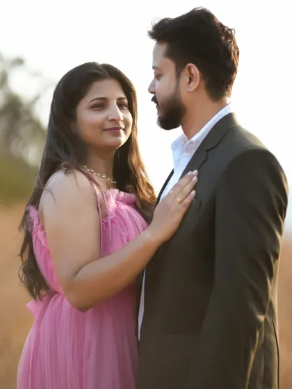 A close-up showing the connection between the couple. The soft pink of the maternity gown enhances the warm and loving feel of this photograph.