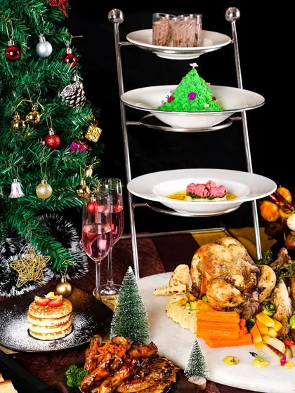 A Christmas feast on a three-tiered stand, featuring a whole roasted turkey and other delicacies. This grand presentation is perfect for promoting a luxurious holiday buffet.