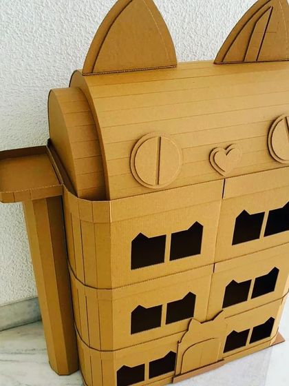 A whimsical cat-themed dollhouse, ready for creative hands. These unpainted structures are perfect for art-based parties or as a special project for your child, encouraging both creativity and imaginative play.