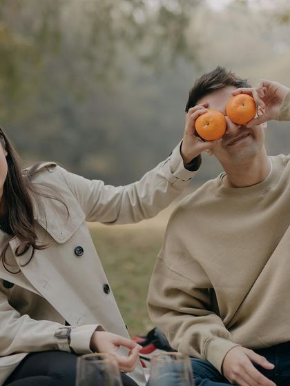 A candid shot of laughter during a playful picnic. Capturing these unposed, genuine interactions is at the heart of what we do.