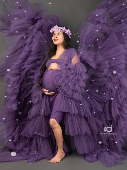 An angelic portrait with the purple gown's fabric creating "wings." This artistic shot is designed to make you feel like the powerful, beautiful mother you are.