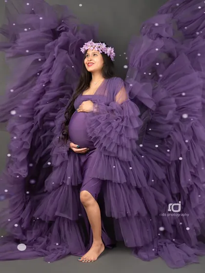 An angelic portrait with the purple gown's fabric creating "wings." This artistic shot is designed to make you feel like the powerful, beautiful mother you are.