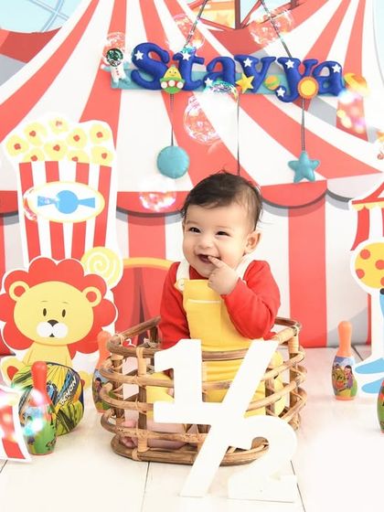 A fun circus theme for a six-month milestone shoot. The bright colors and playful props are perfect for capturing the curious nature of a sitter-stage baby.