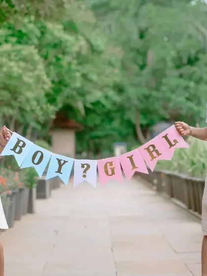 A fun gender reveal moment during a maternity shoot. Using props like banners adds a playful element to your session as you anticipate your baby's arrival.