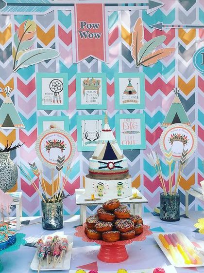 A closer look at the Aztec-themed dessert table, featuring a teepee-shaped cake and treats that match the colorful, wild-and-free party decor.