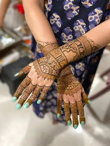 An elegant engagement mehendi with personalized initials. The design is dense and intricate, perfect for celebrating a special commitment.