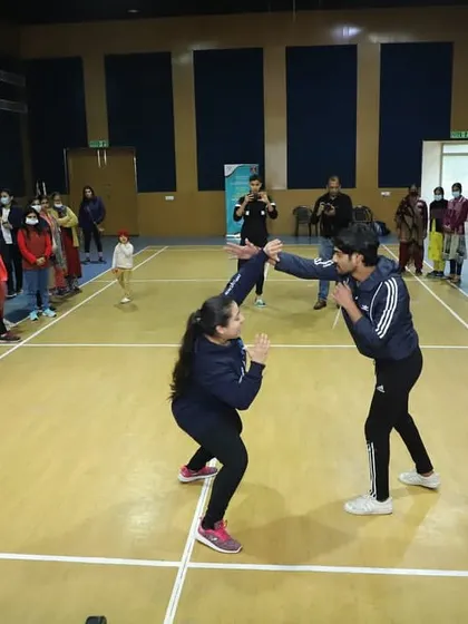 During a workshop, a student practices a defensive block and counter. The goal is to simultaneously defend and attack, overwhelming the opponent and shutting down their aggression.