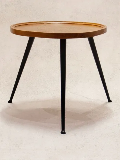 Another view of the 'Tipoy' side table, showcasing its clean design. The raised edge of the teak top is a practical detail to keep items secure.