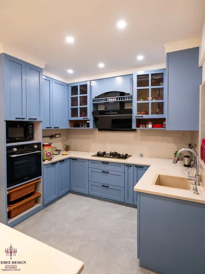 A beautiful kitchen with powder blue PU-painted cabinets, showcasing a soft and classic aesthetic.