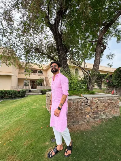 A similar shot in the pink kurta, capturing a moment of quiet confidence before the show begins.
