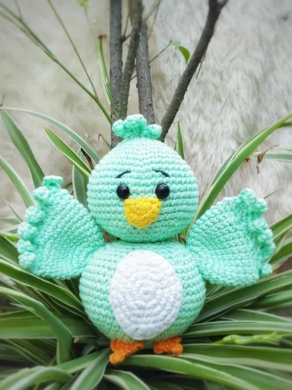 Here is Koda the bird all by himself. He is a sweet little amigurumi made with mint green yarn, with cute wings and a little tuft on his head.