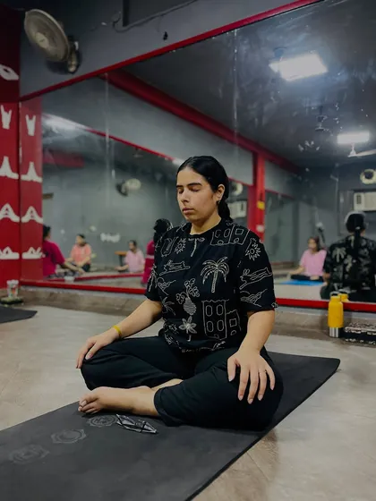 Another student deep in meditation, embodying the principle of finding a stable and comfortable posture.