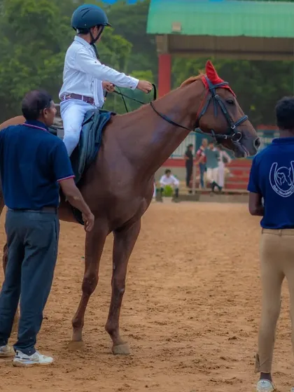 A young rider receives instruction from our coaches during a training session, preparing for an upcoming competition.
