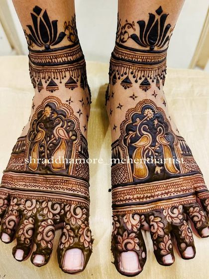 A beautiful and traditional design for bridal feet. This piece features two peacocks within an ornate arch, with delicate floral patterns on the toes.
