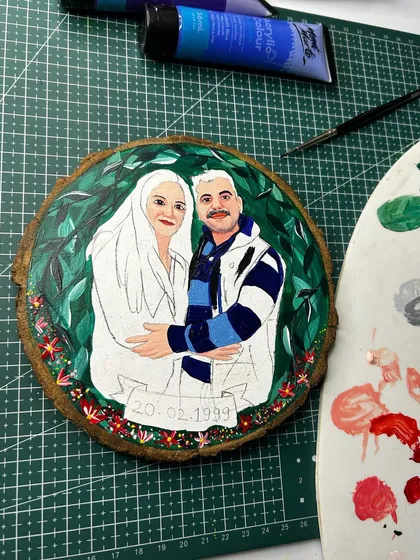 A behind-the-scenes look at my painting setup for a wooden slice portrait. You can see the color palette I used to bring the couple's features and clothing to life.
