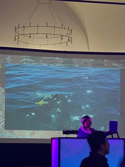 A view of my setup at a gala, with my visuals projected on a large screen. I can provide a full audio-visual experience for any event.